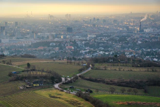 Rolling hills lead to a distant city.
