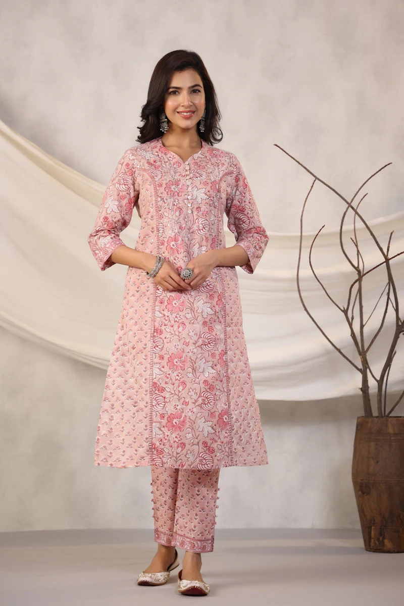 Woman in a pink floral kurta — designer suit