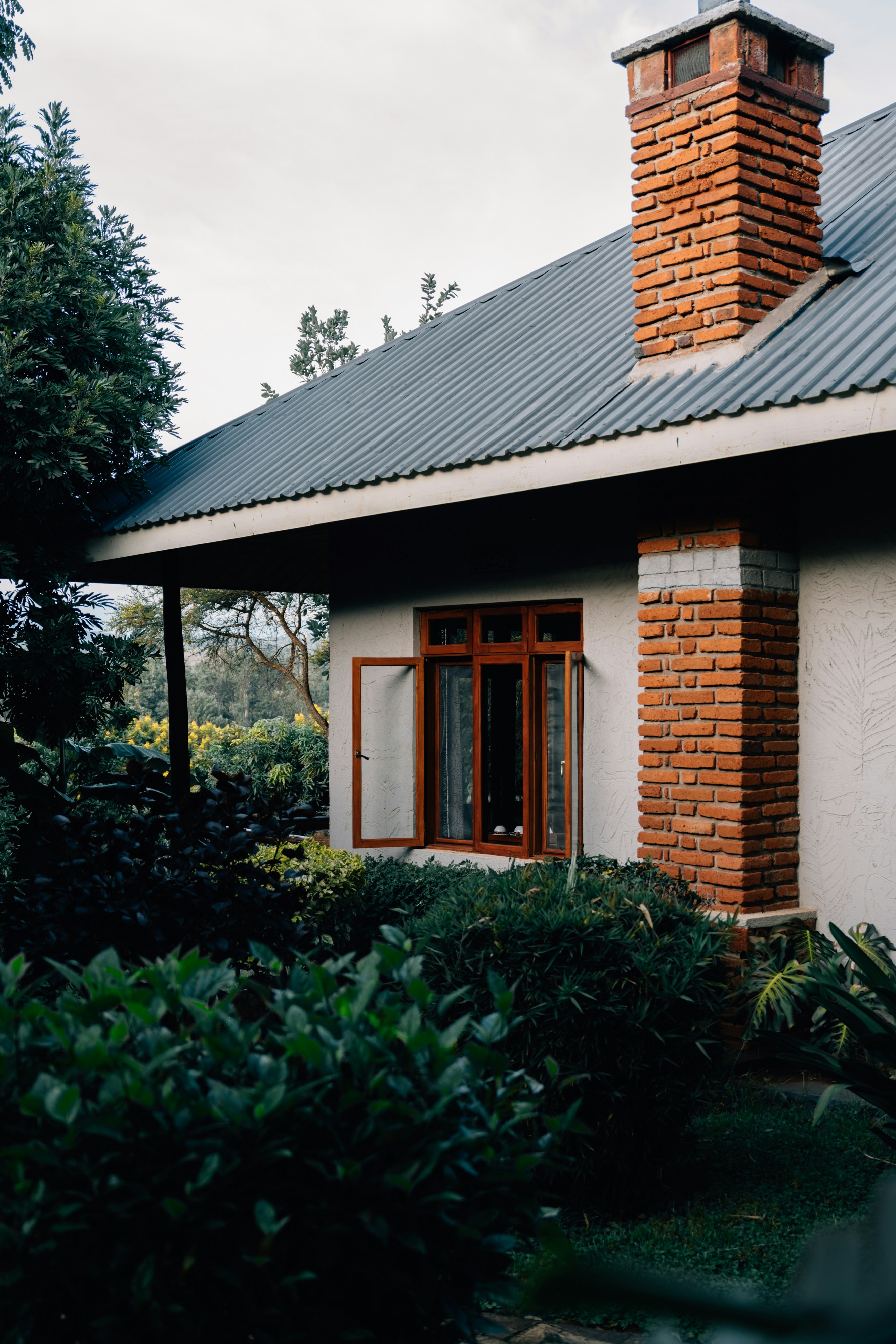 Cozy house with an open window and brick chimney.