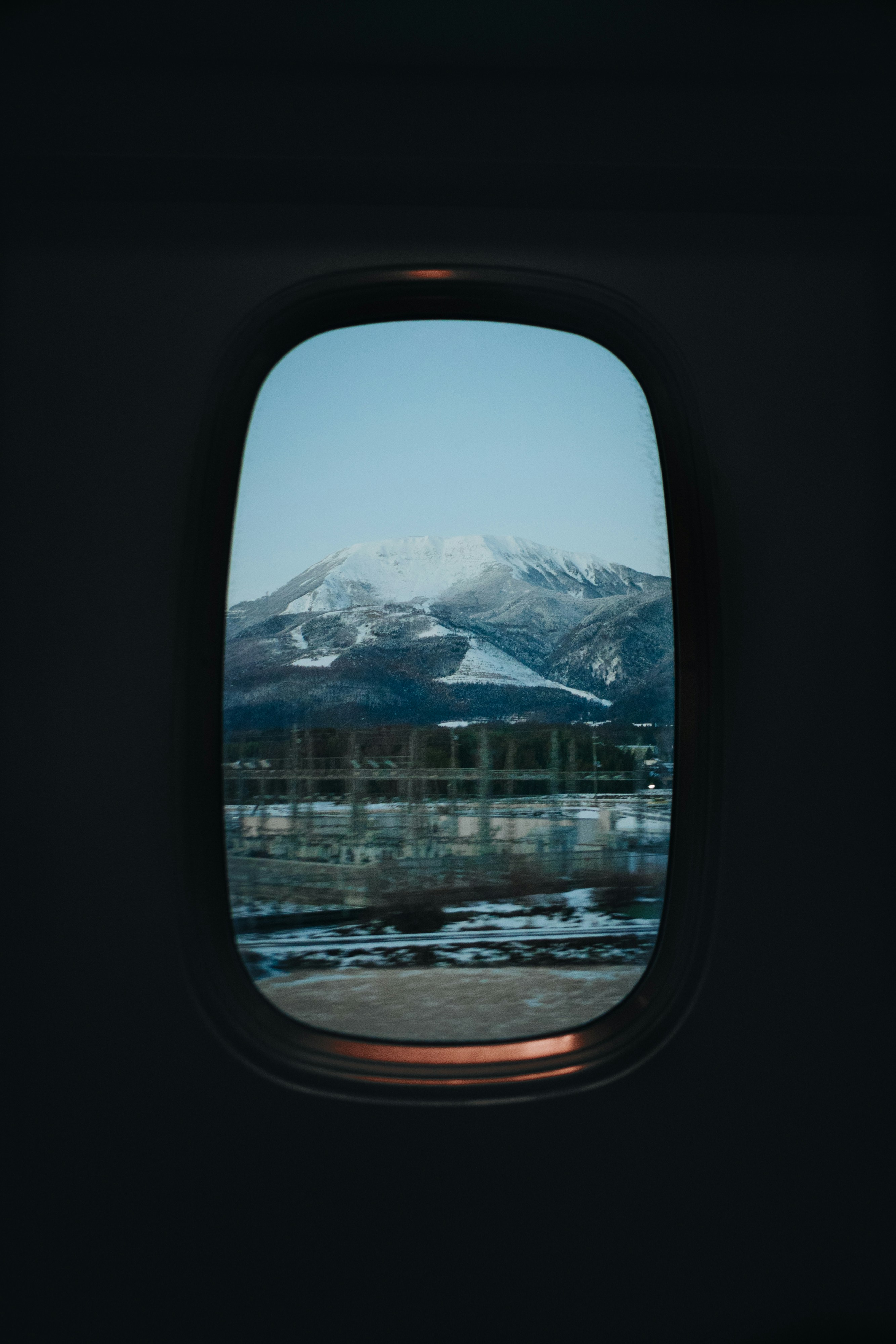 Mountain landscape viewed through a window.