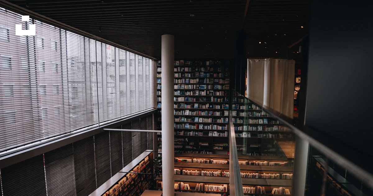 A modern library with tall bookshelves and windows. photo – Free Japan ...