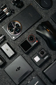 Tech gadgets and accessories arranged on a dark background.