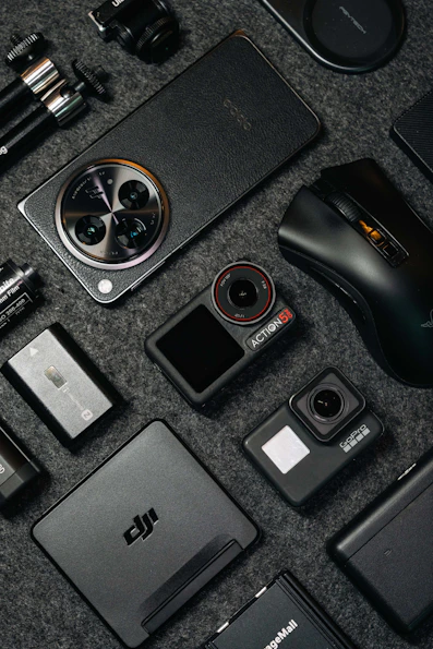 Tech gadgets and accessories arranged on a dark background.