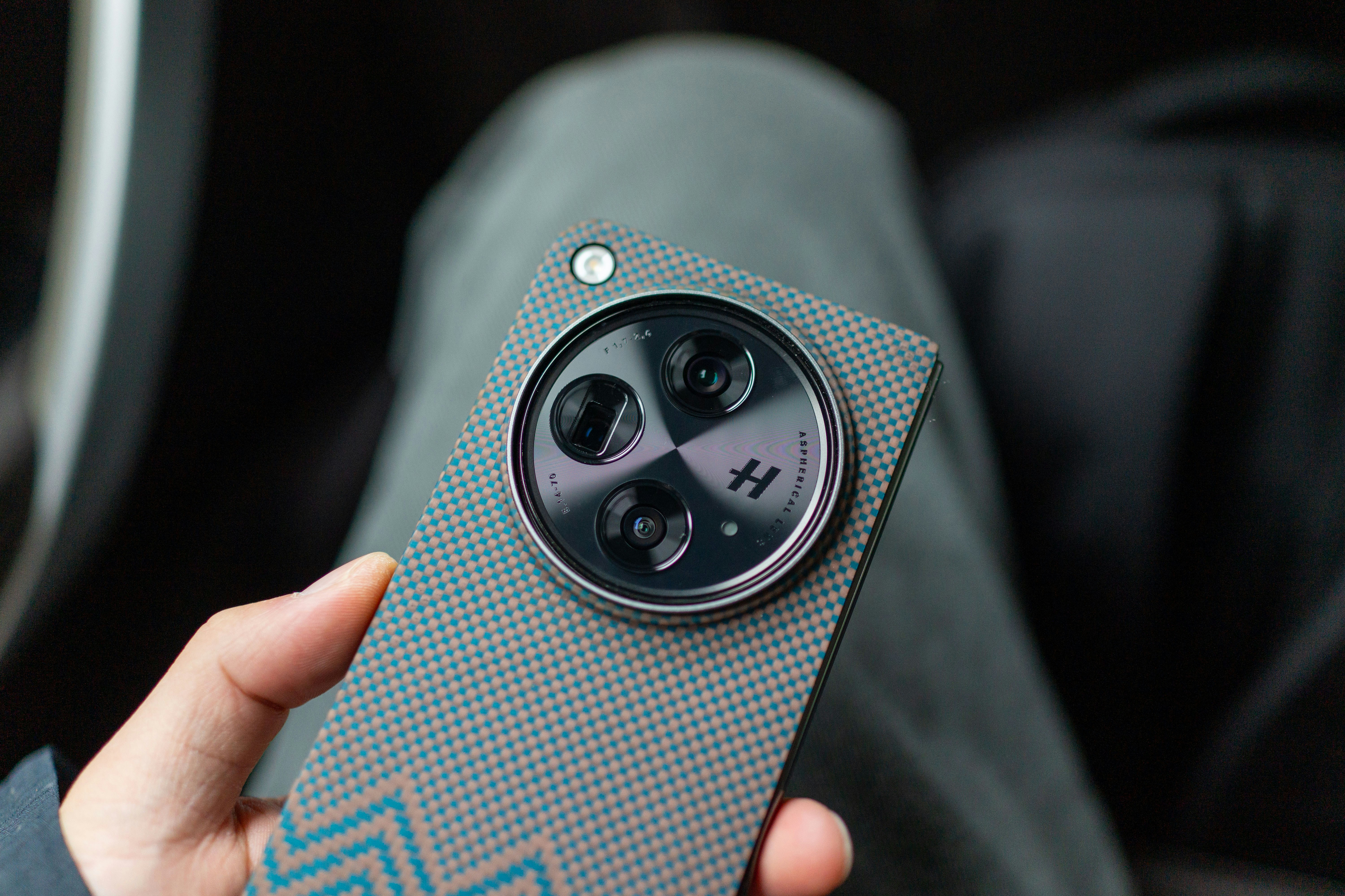 A person is holding a unique smartphone