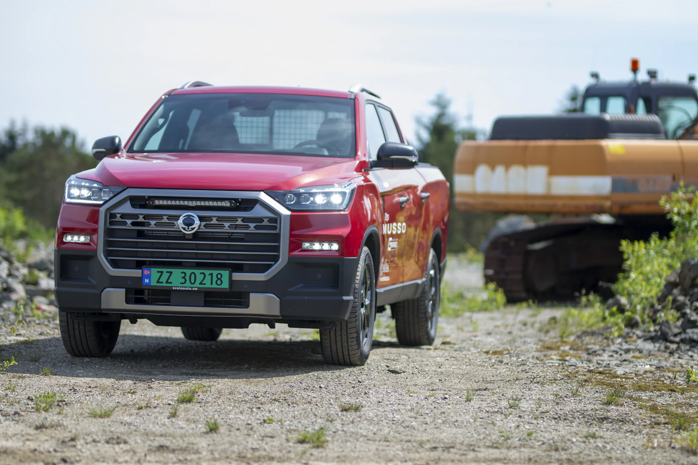 Red Toyota-style truck on a dirt trail
