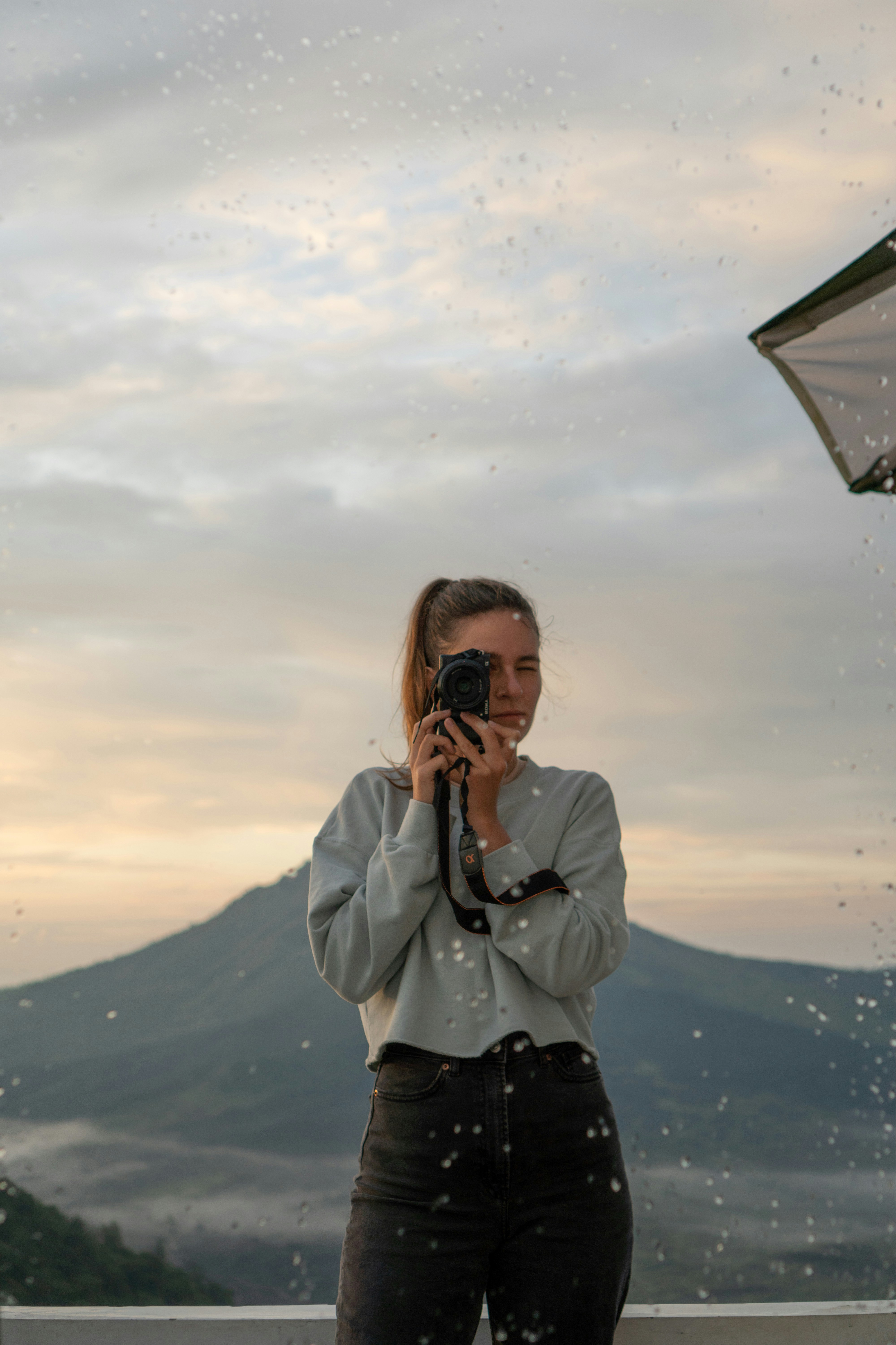 Photographer takes a photo of a mountain landscape.