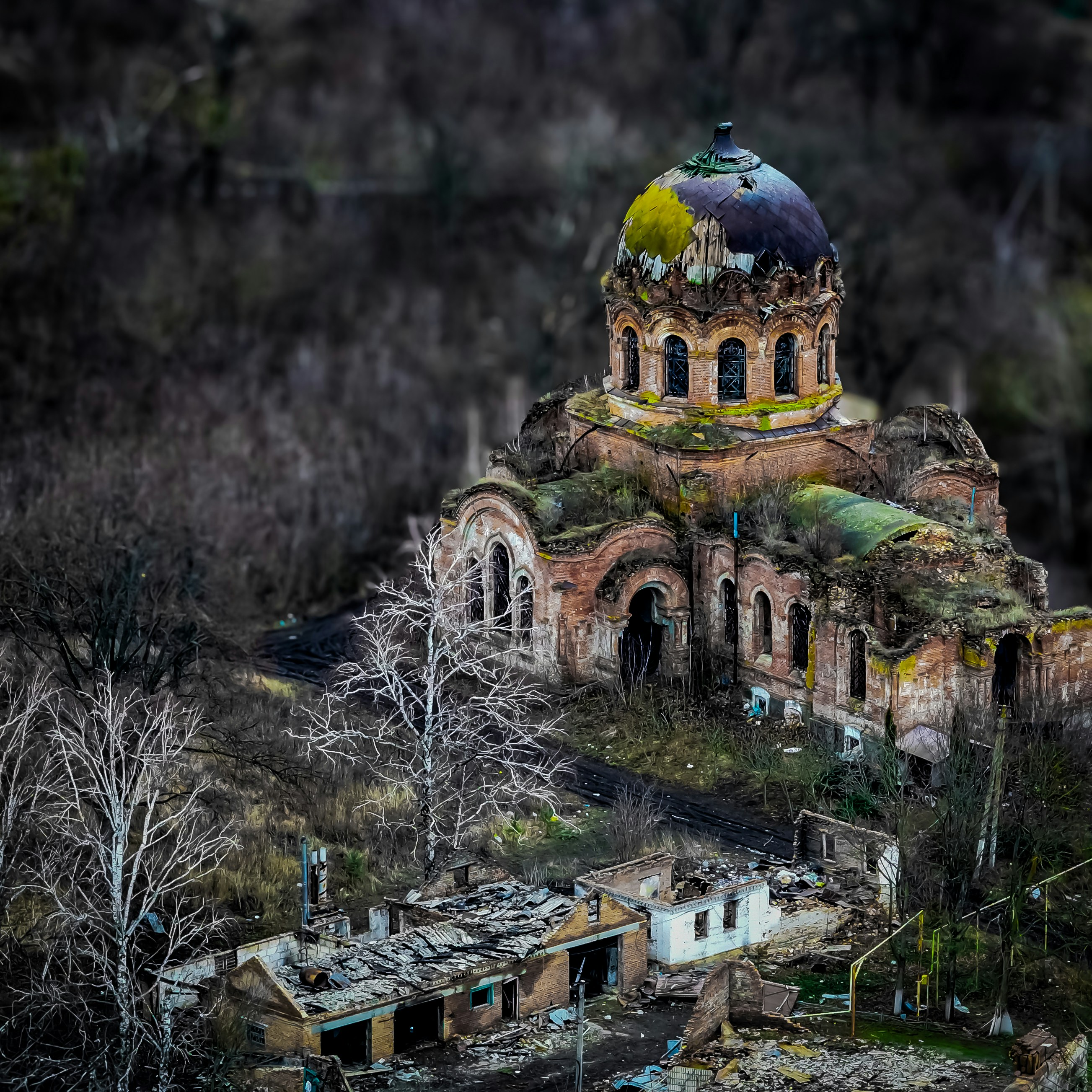 A damaged church stands amid the ruins.