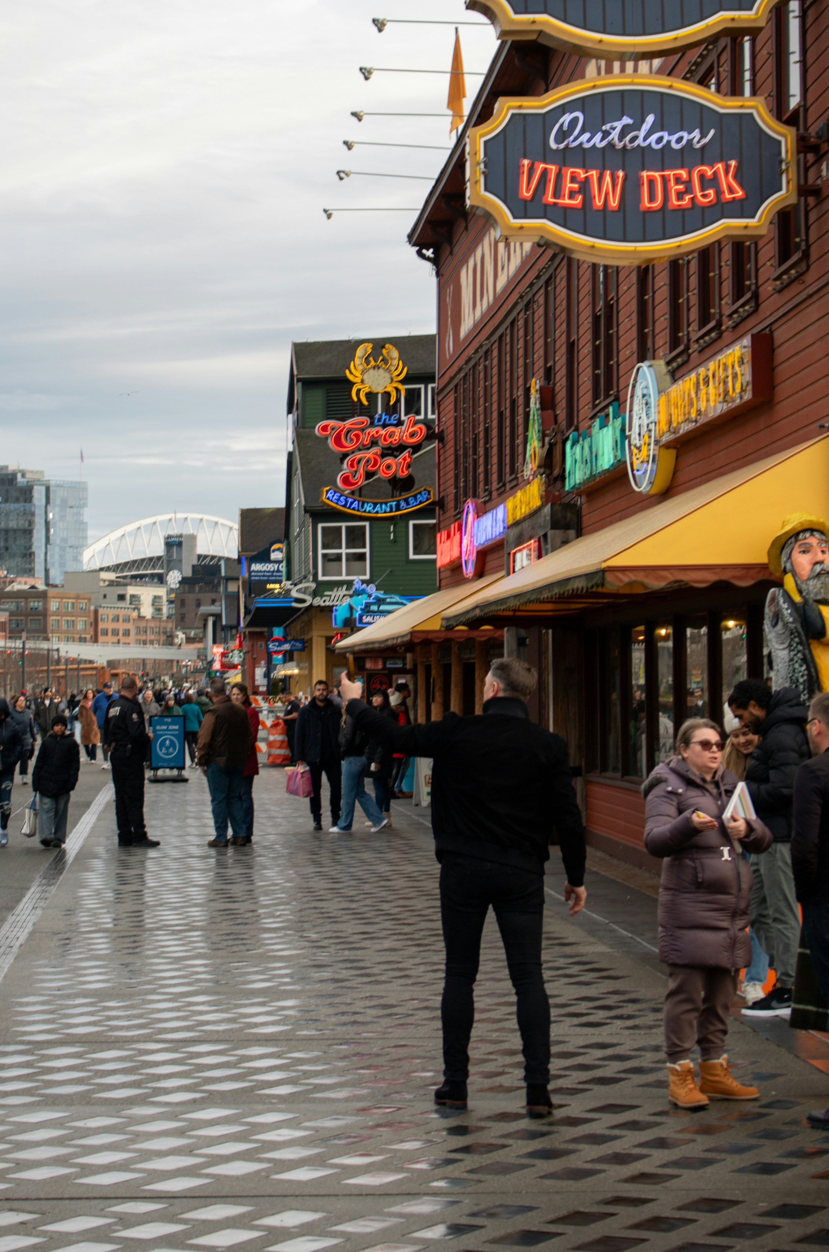 Busy street scene near the "outdoor view deck" sign.