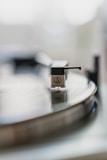 A turntable's needle playing a vinyl record.