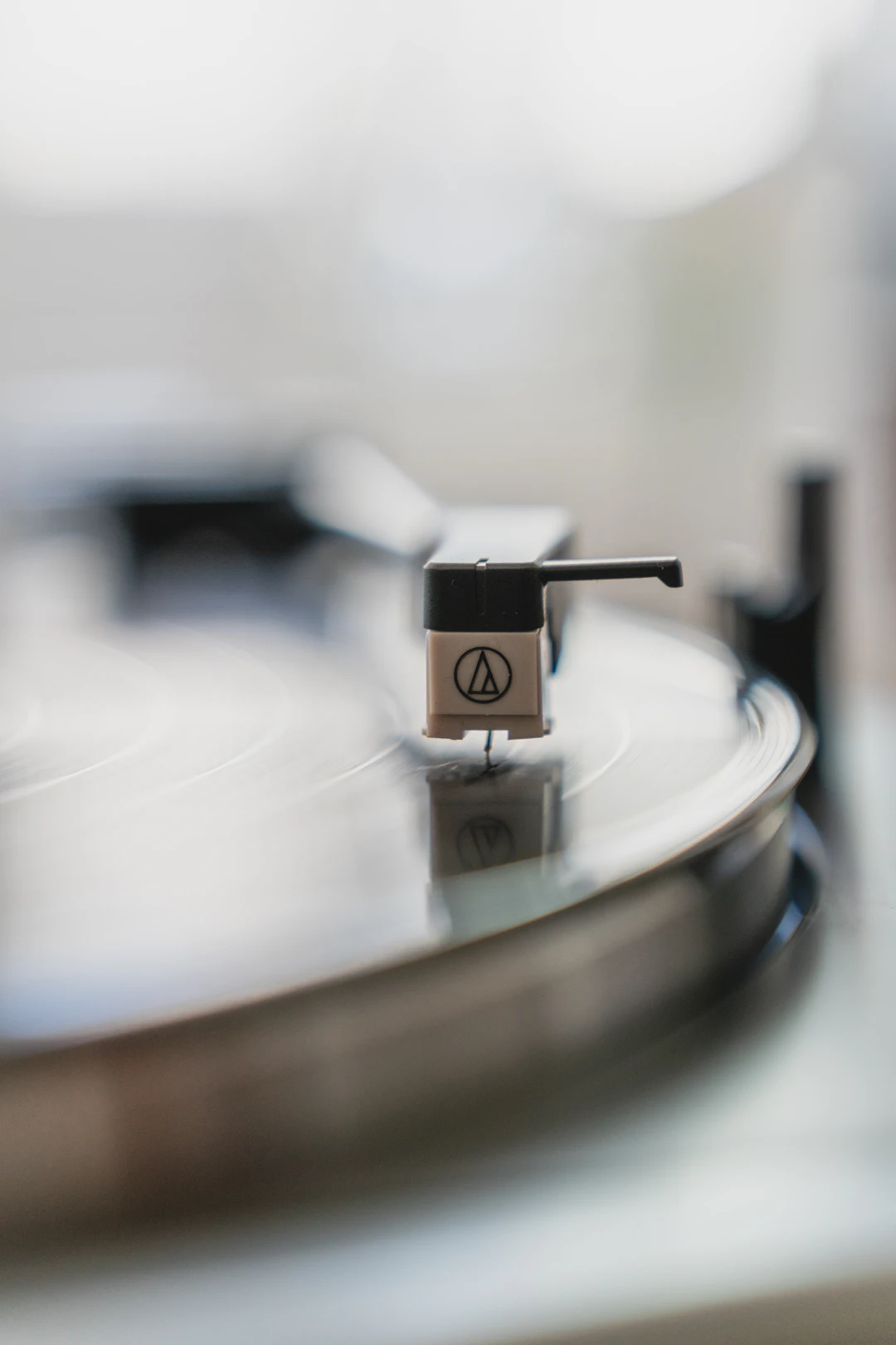 A turntable needle playing a vinyl record
