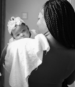 A mother lovingly holds her precious baby girl.