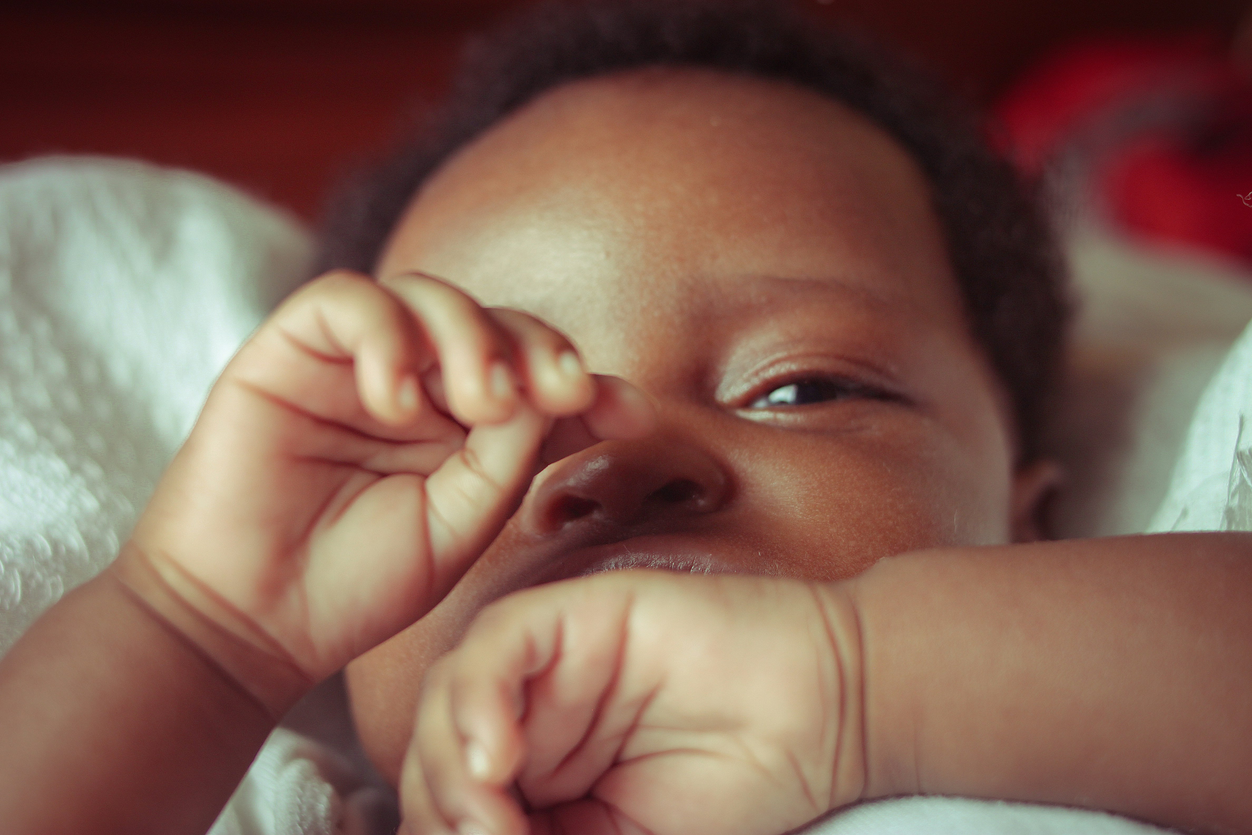 Fussy 4-month-old baby rubbing their eyes - how to help baby through 4 month sleep regression