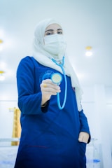 A doctor holds a stethoscope.