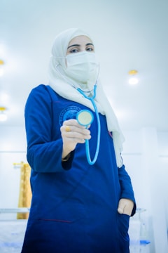 A doctor holds a stethoscope.