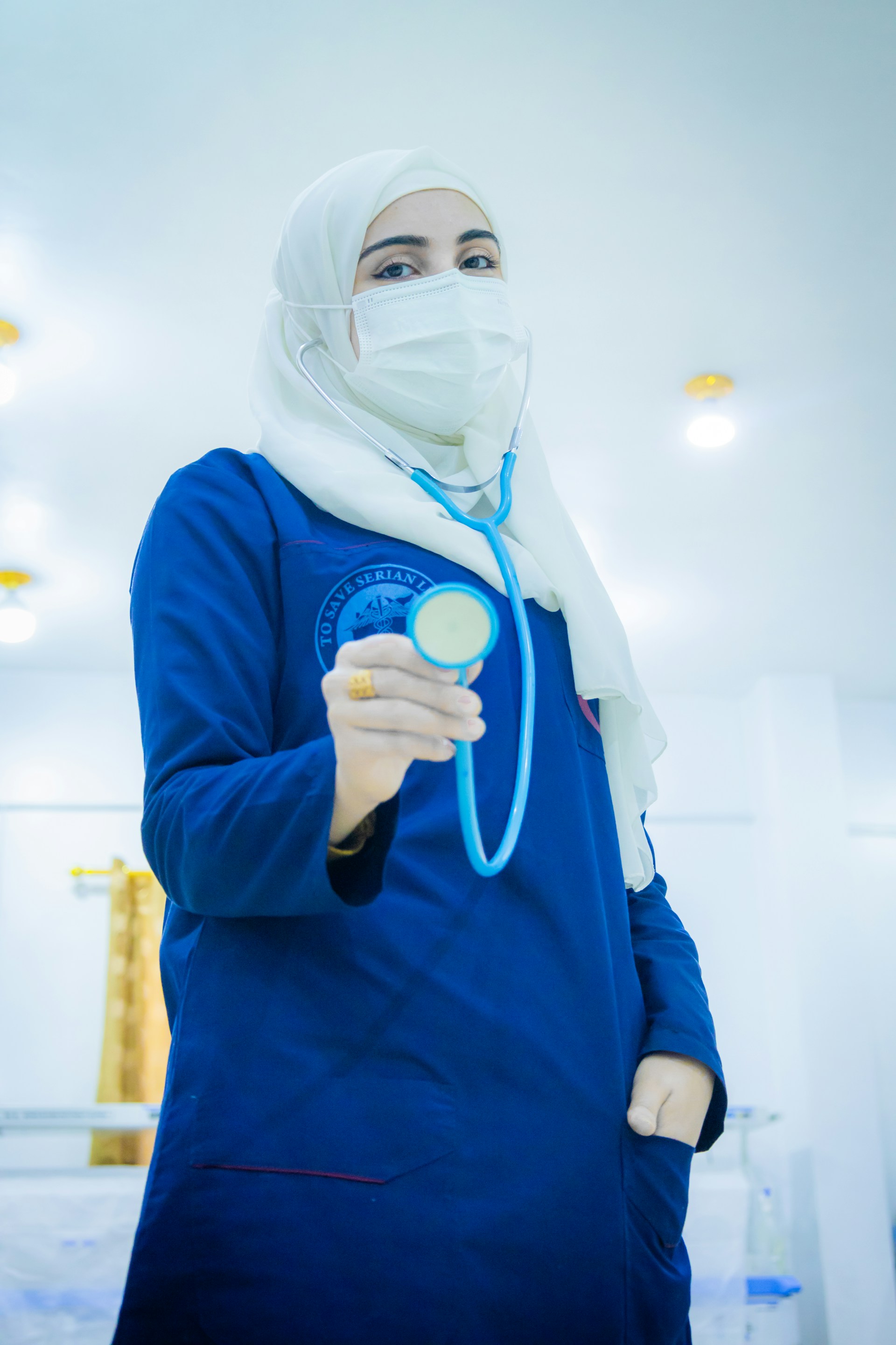 A doctor holds a stethoscope.