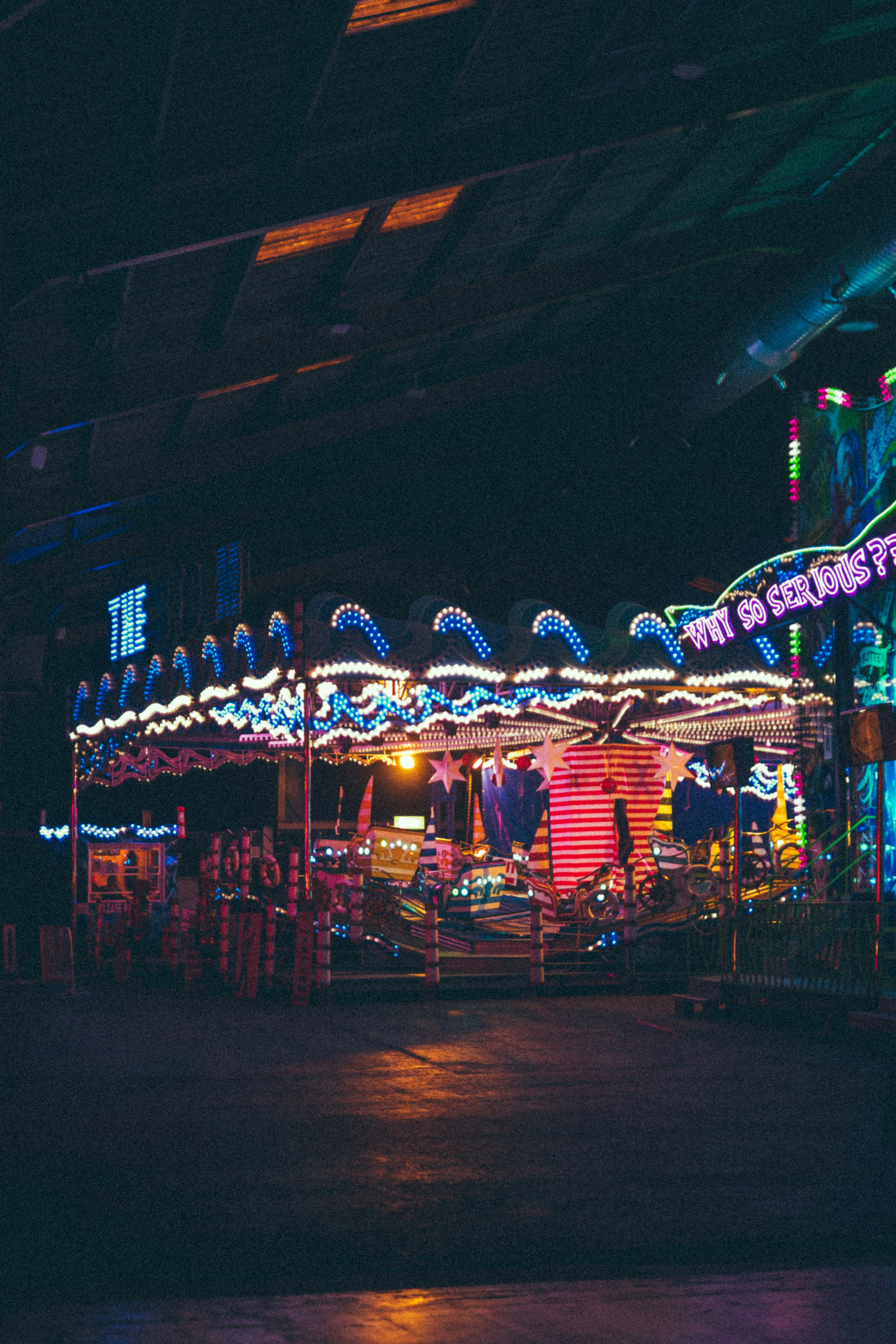 A brightly lit carnival ride at night.