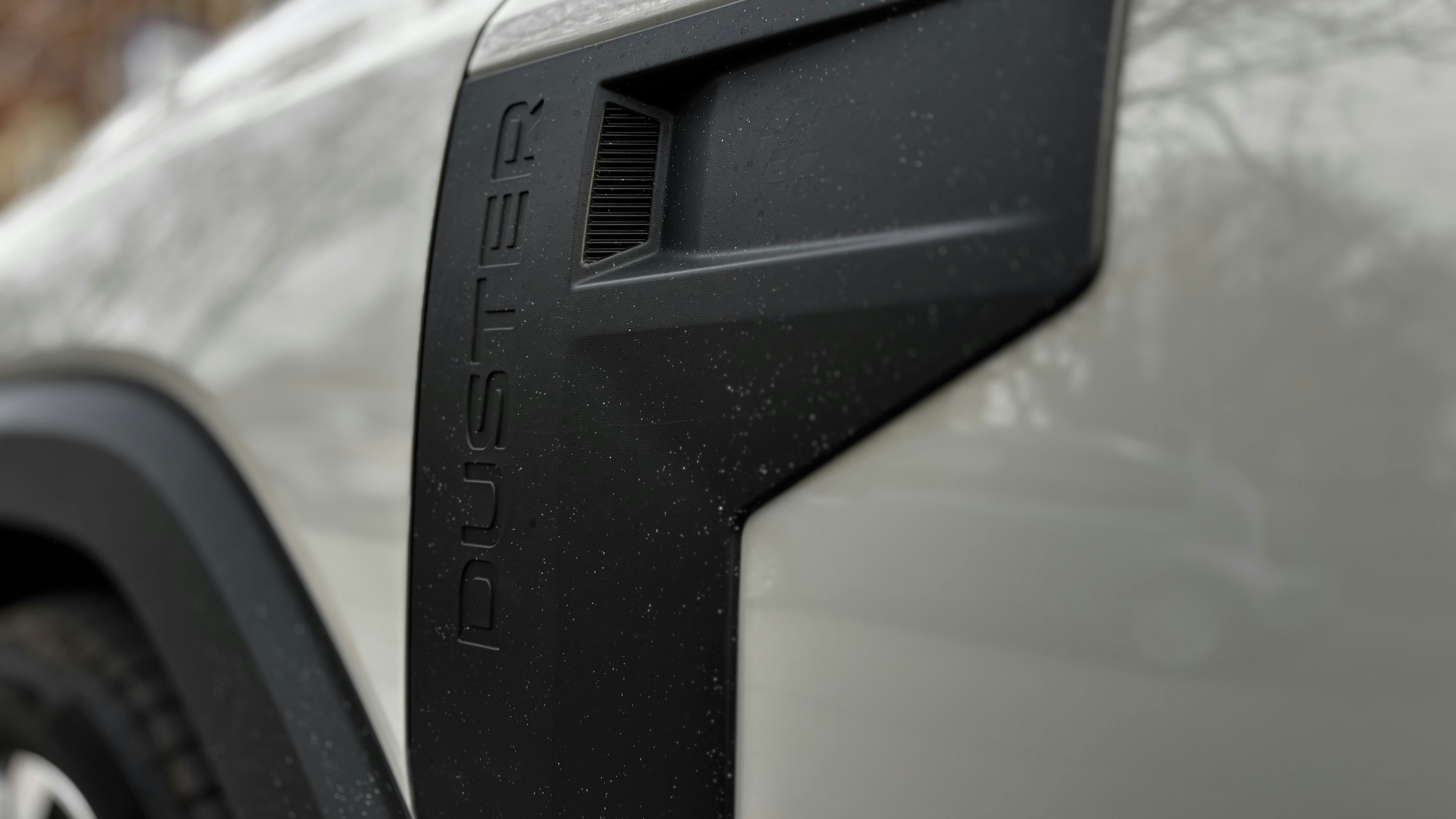 Technician using a tablet to run battery diagnostics on an electric vehicle