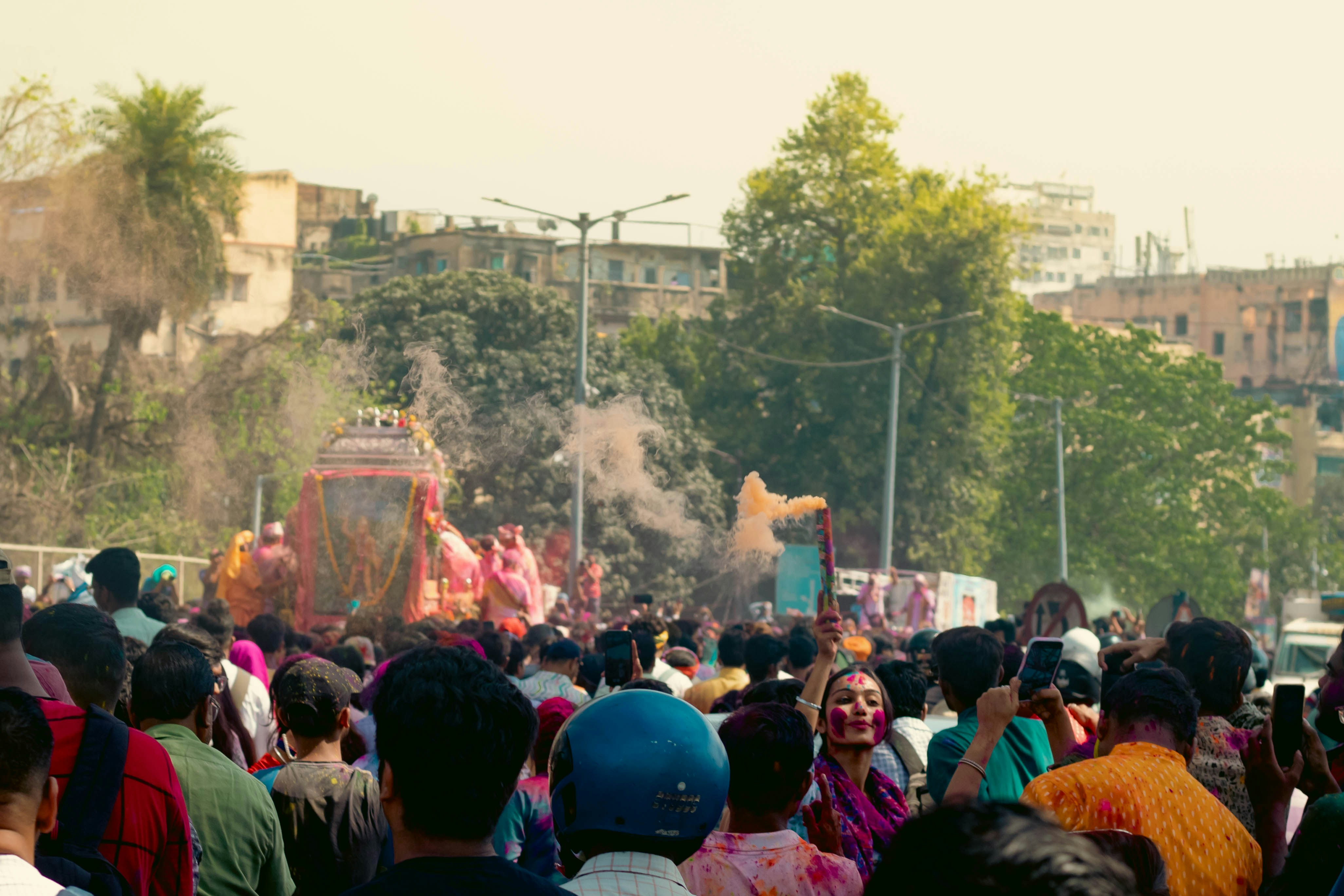 People celebrate a colorful festival together in a crowd.