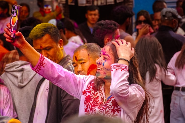 People celebrating the festival of colours in Nepal with vibrant powders and joyful energy