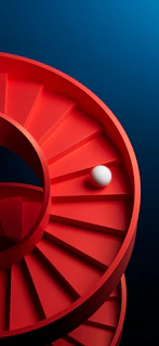 A ball rolls down a red spiral staircase