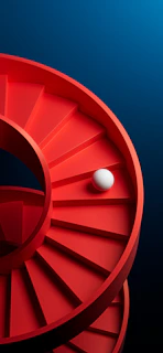 A ball rolls down a red spiral staircase