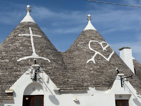 Tiled roofs feature symbols on a sunny day.