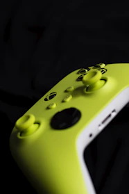 A lime green video game controller on black.
