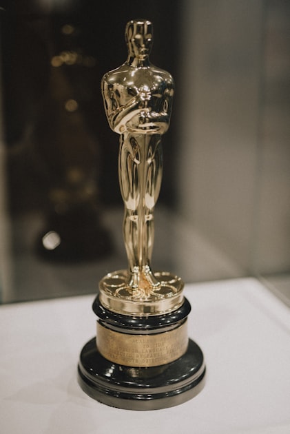 Golden Oscar statuette trophy gleaming against a dark background