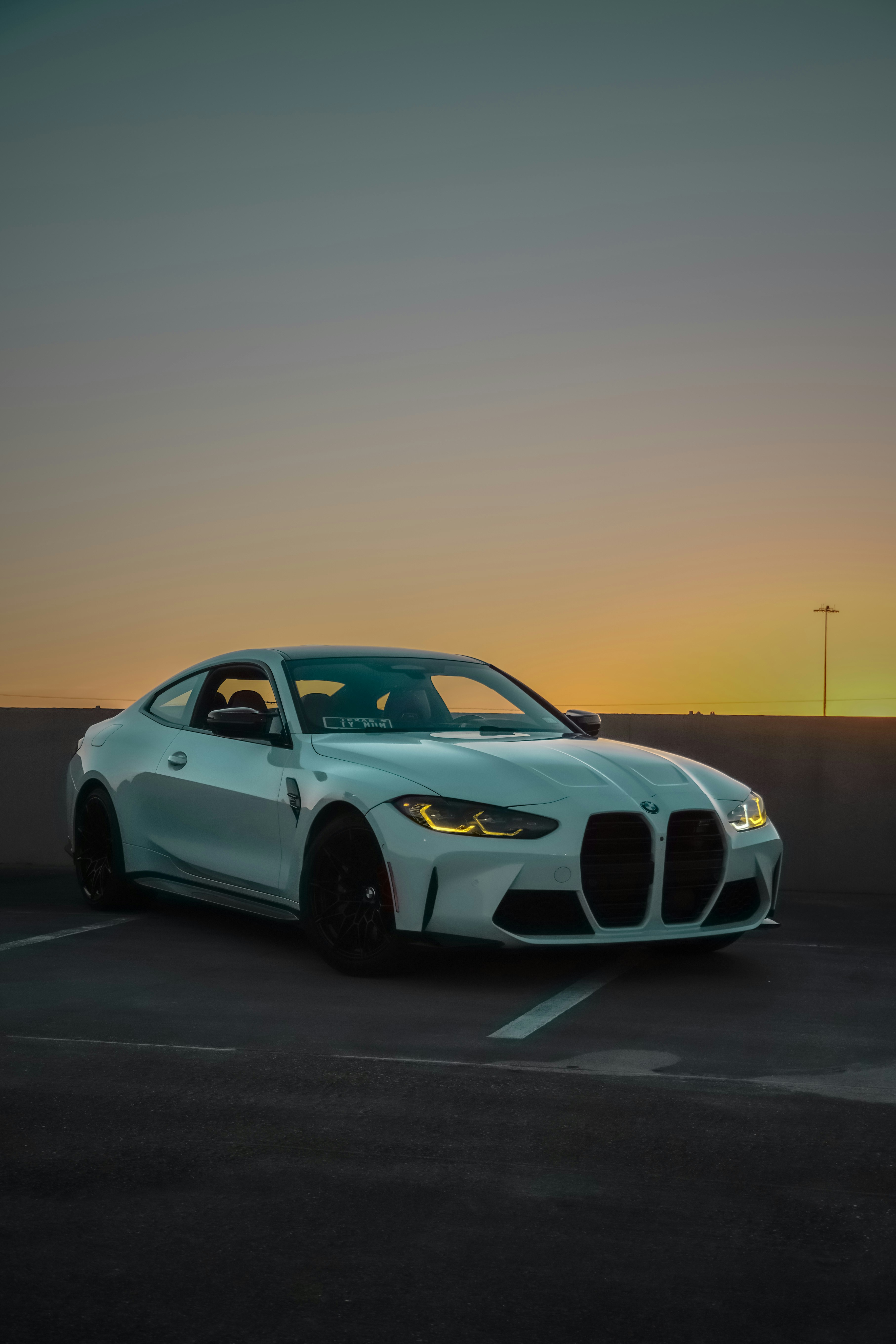 A white BMW m4 sits at sunset. photo – Free Car Image on Unsplash, image size:3000x4499