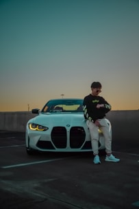 A man poses with his white bmw.