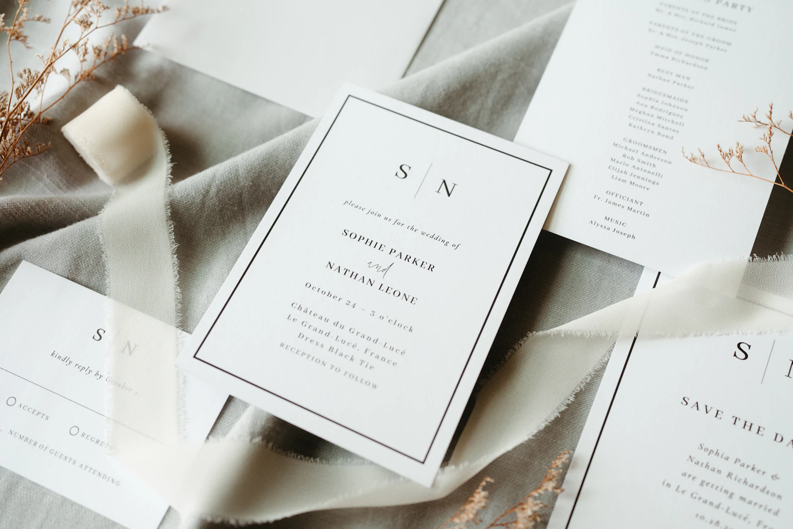 Wedding stationery and an envelope laid out on soft fabric