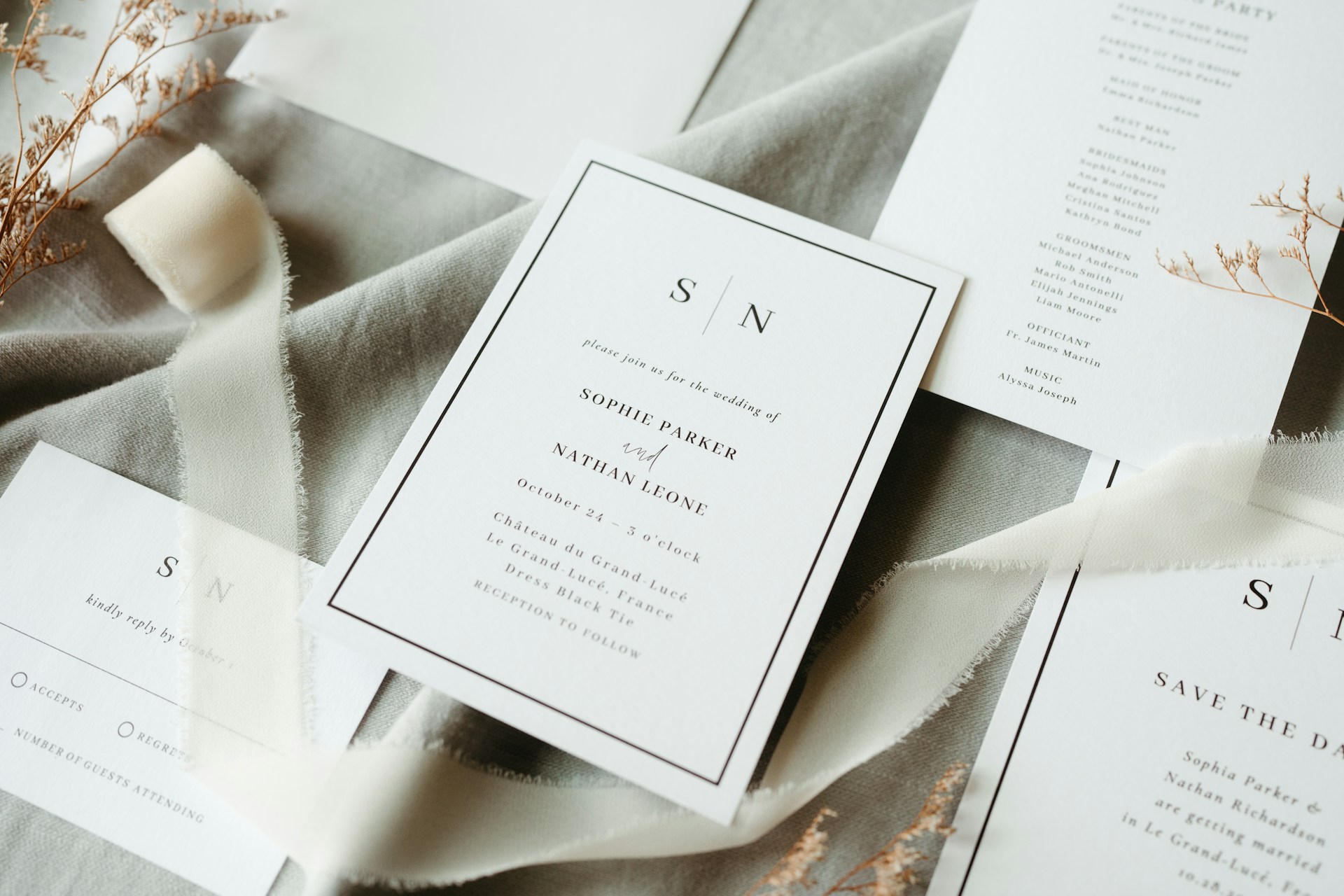 Wedding stationery is arranged on fabric.