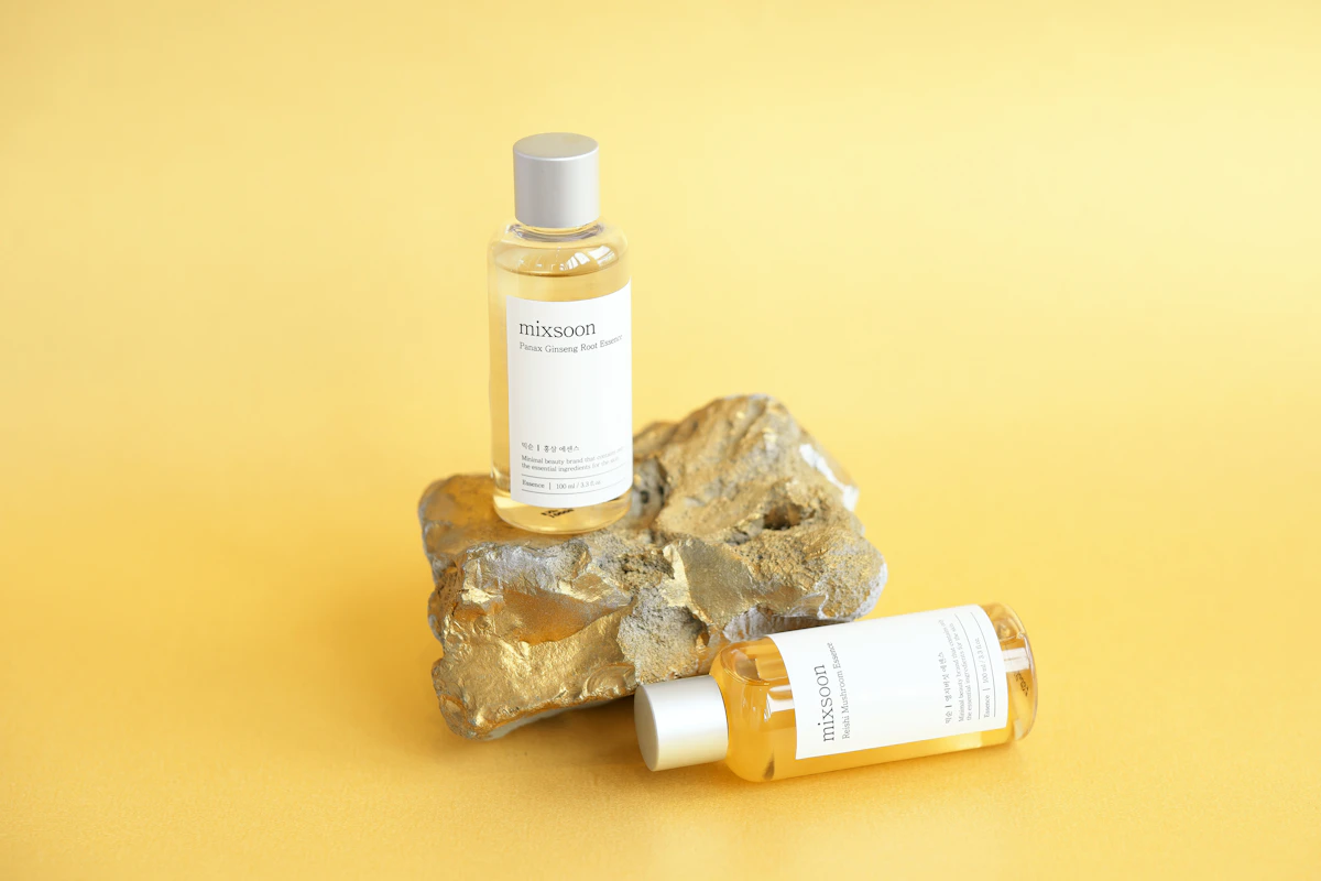 Skincare product bottles displayed on a rock surface