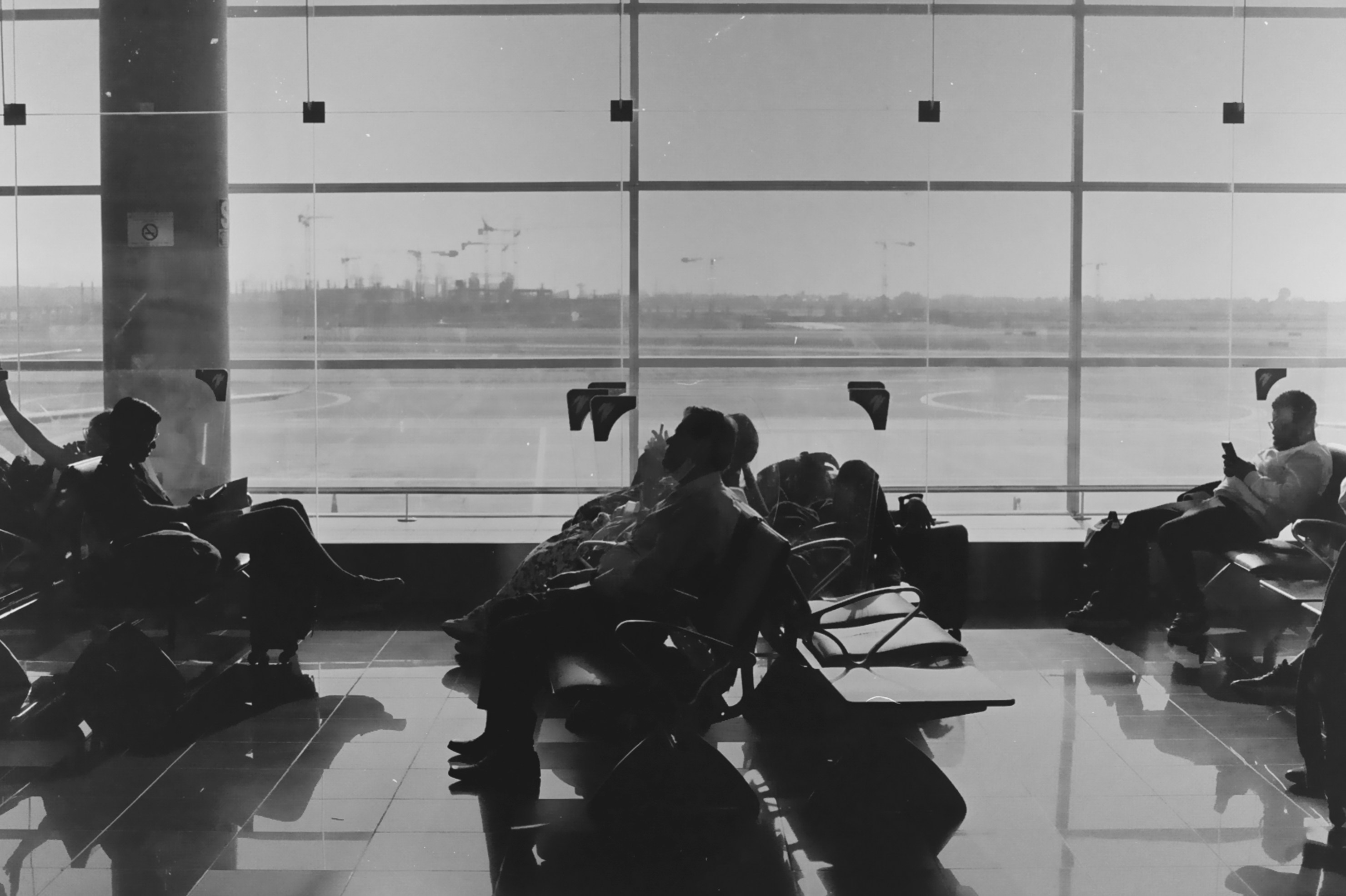 People are waiting in an airport terminal.