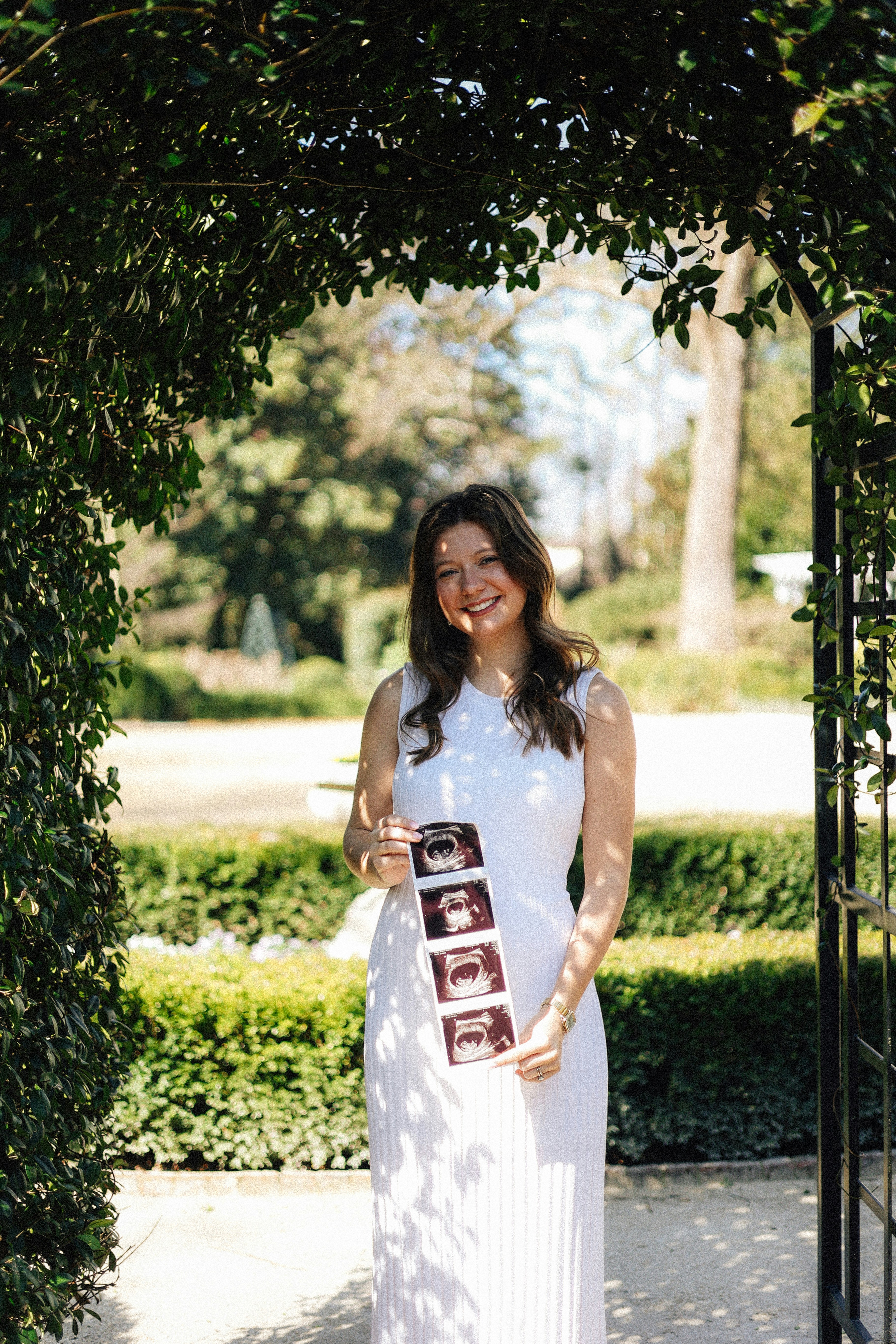 Pregnant woman is happily showing off her ultrasound.