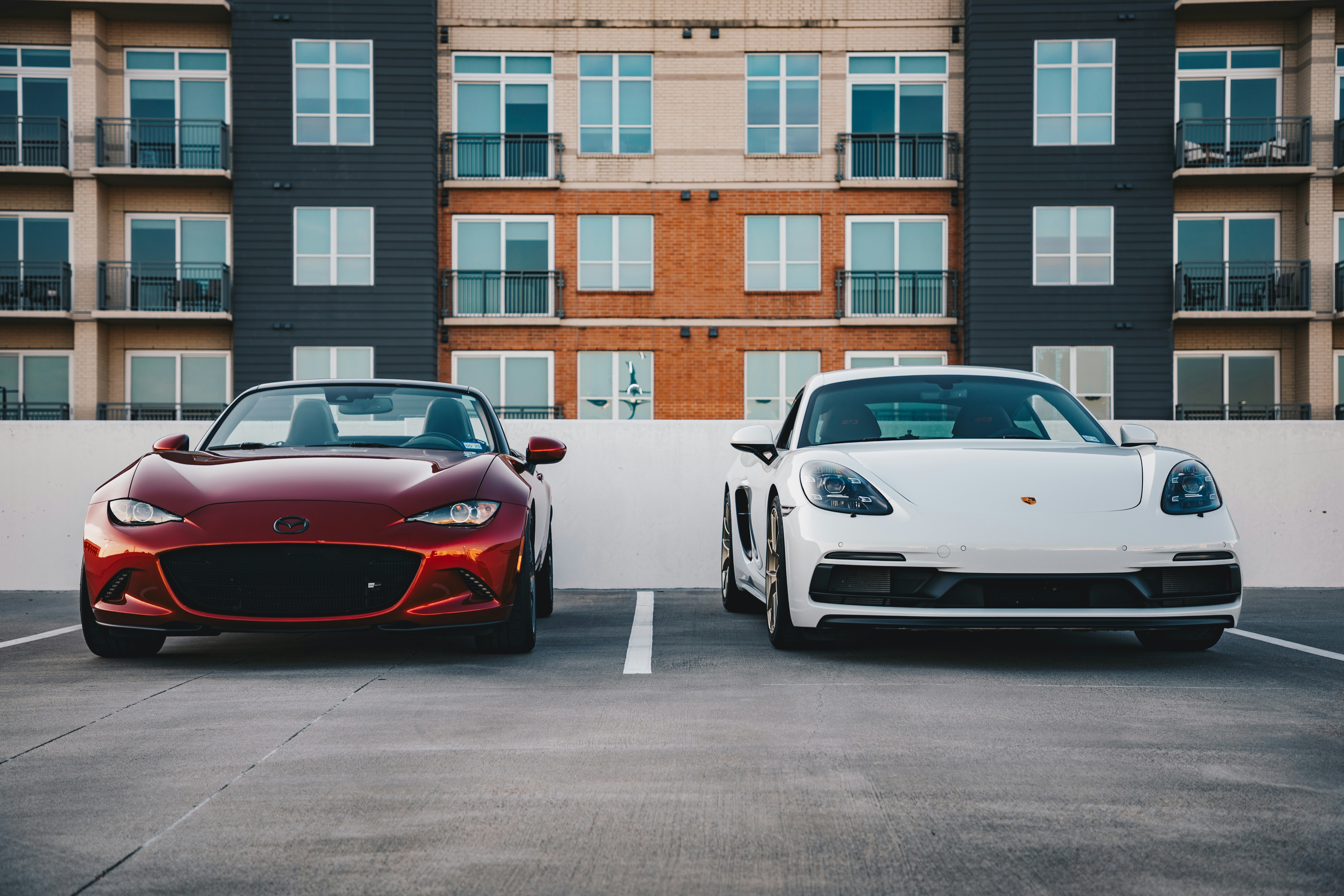 Tesla Model 3 sedan parked next to a Model Y crossover in a modern setting