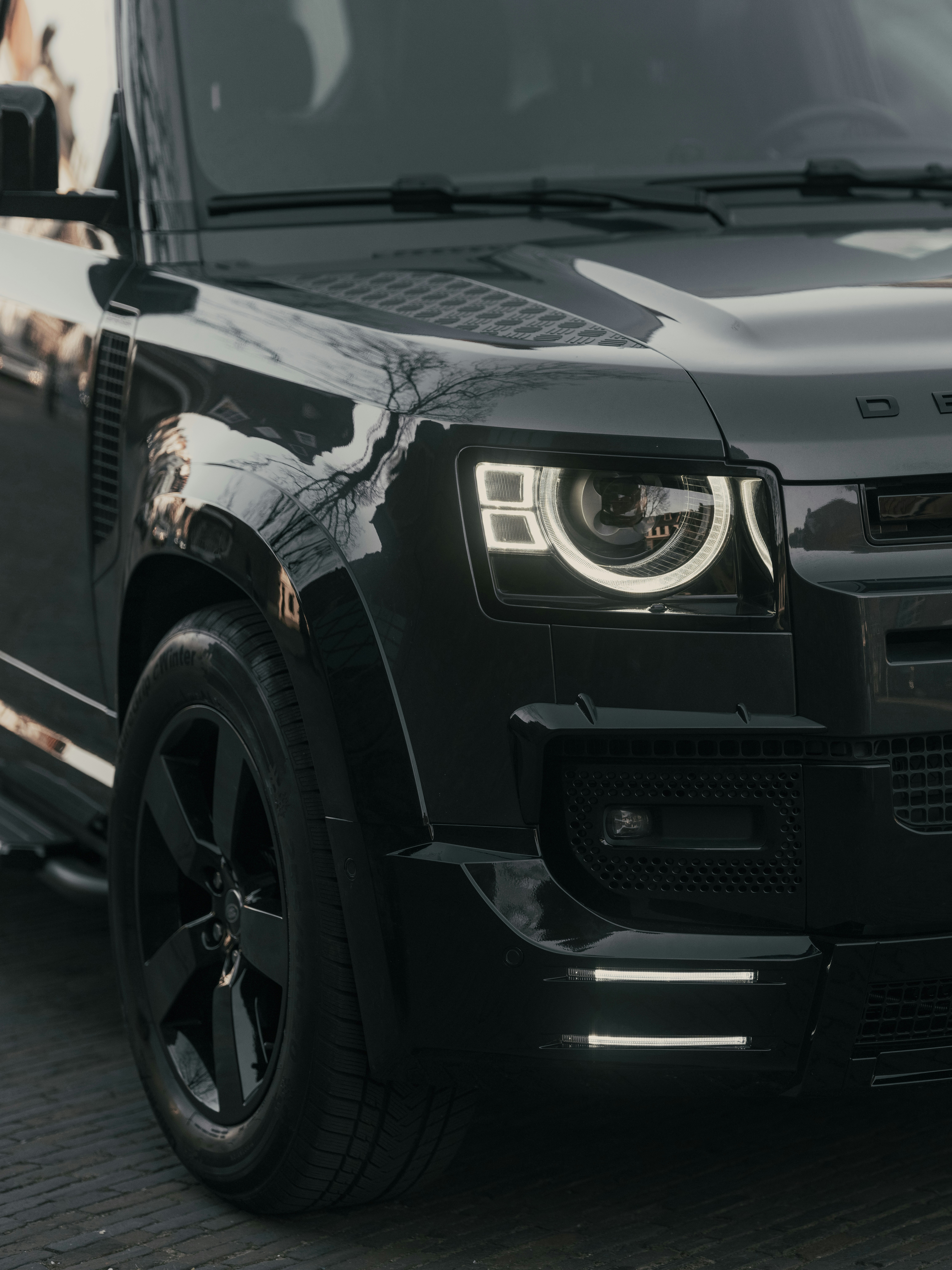 A sleek, black land rover defender.
