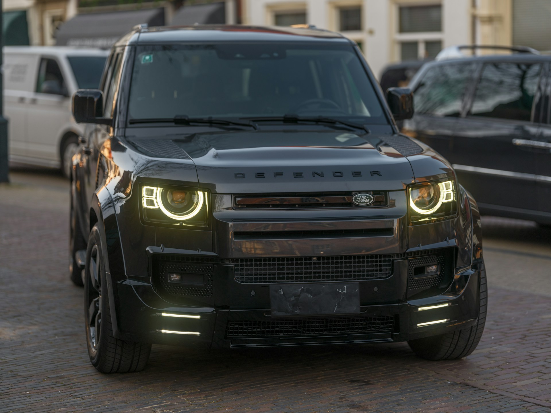 Black land rover defender parked outdoors.