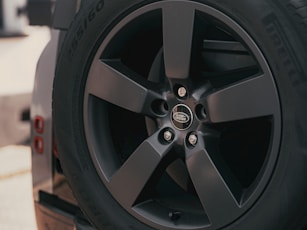 A close up of a land rover's wheel.
