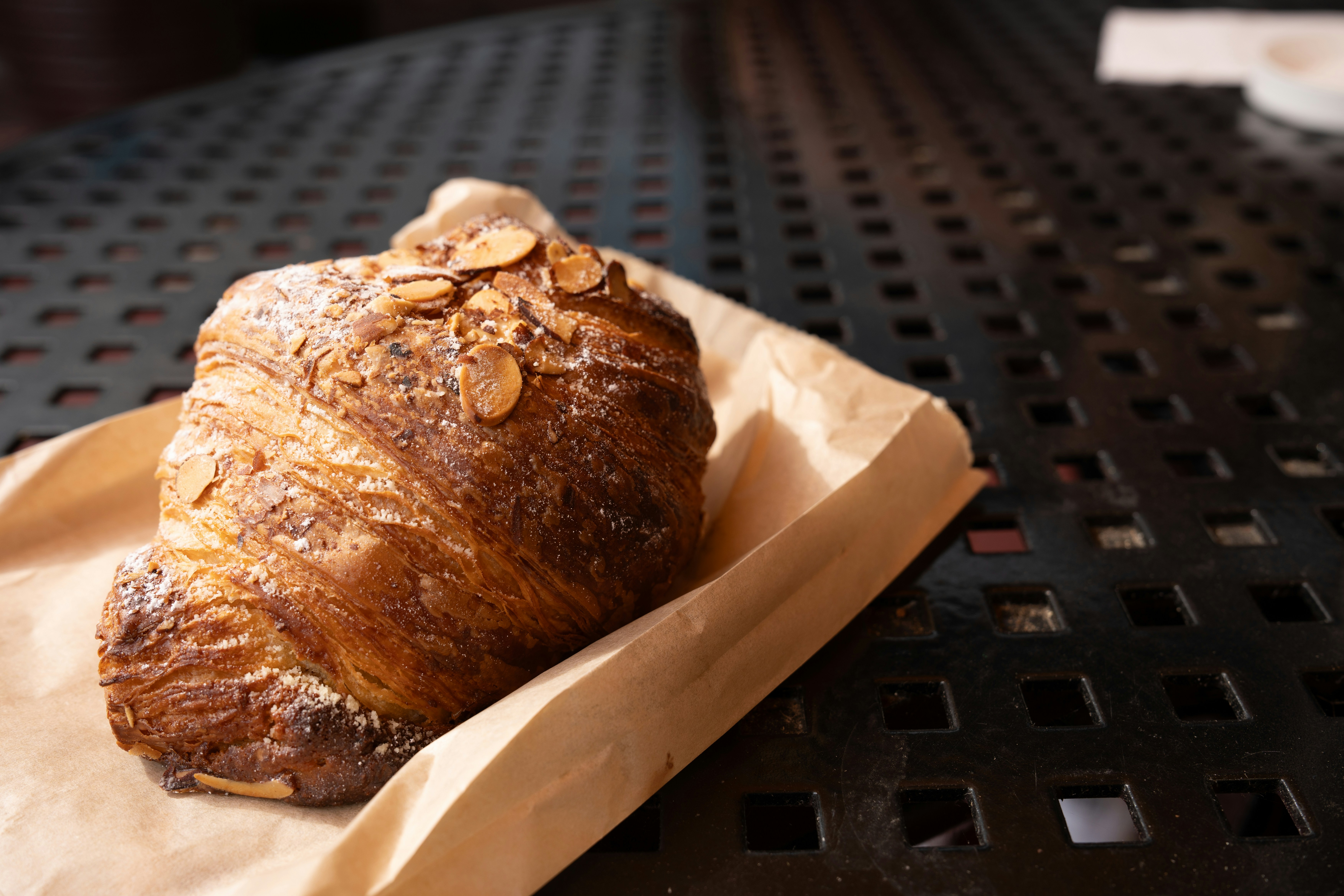 Delicious almond croissant on a table.