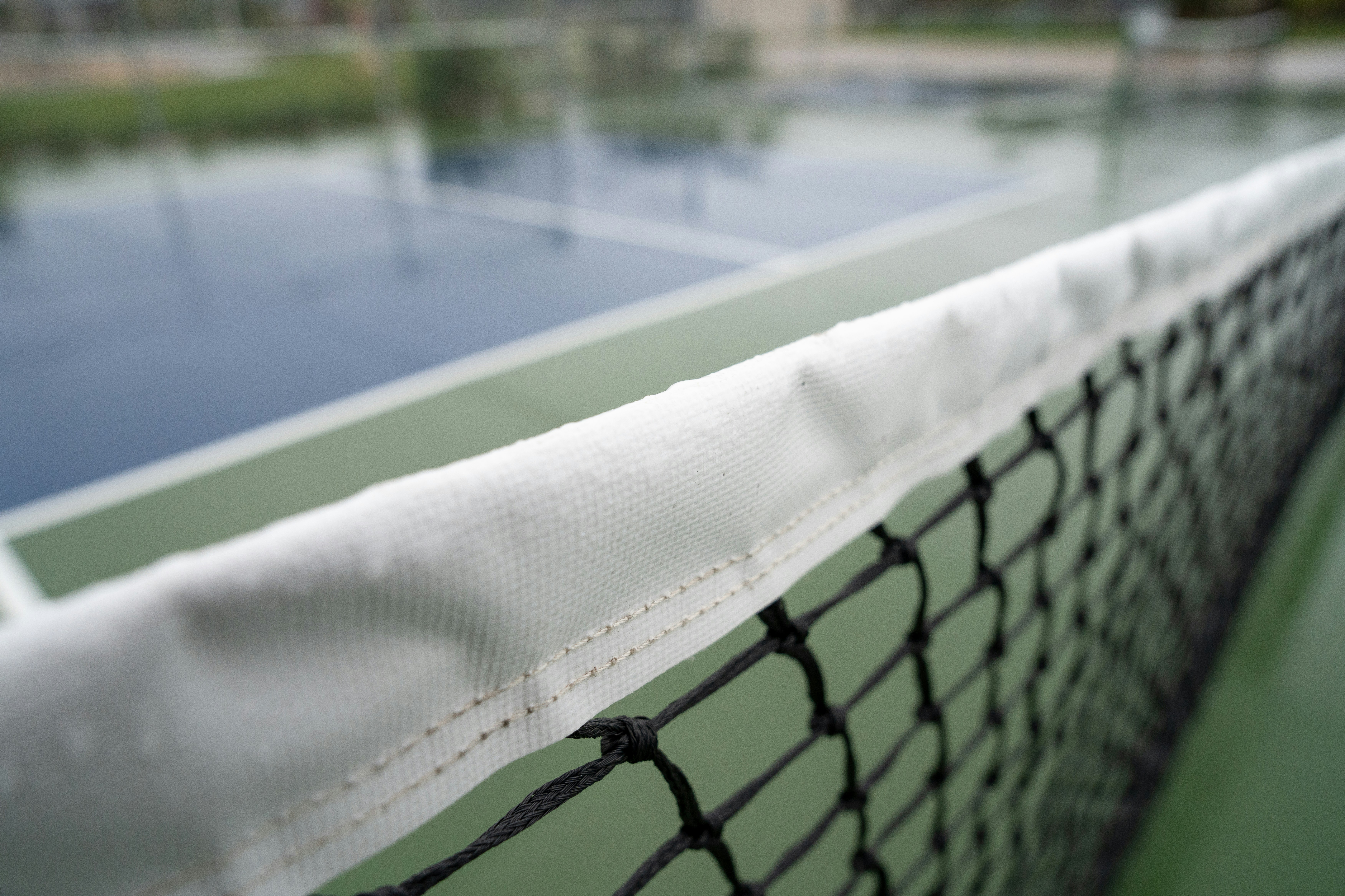 A close-up of a tennis court net.