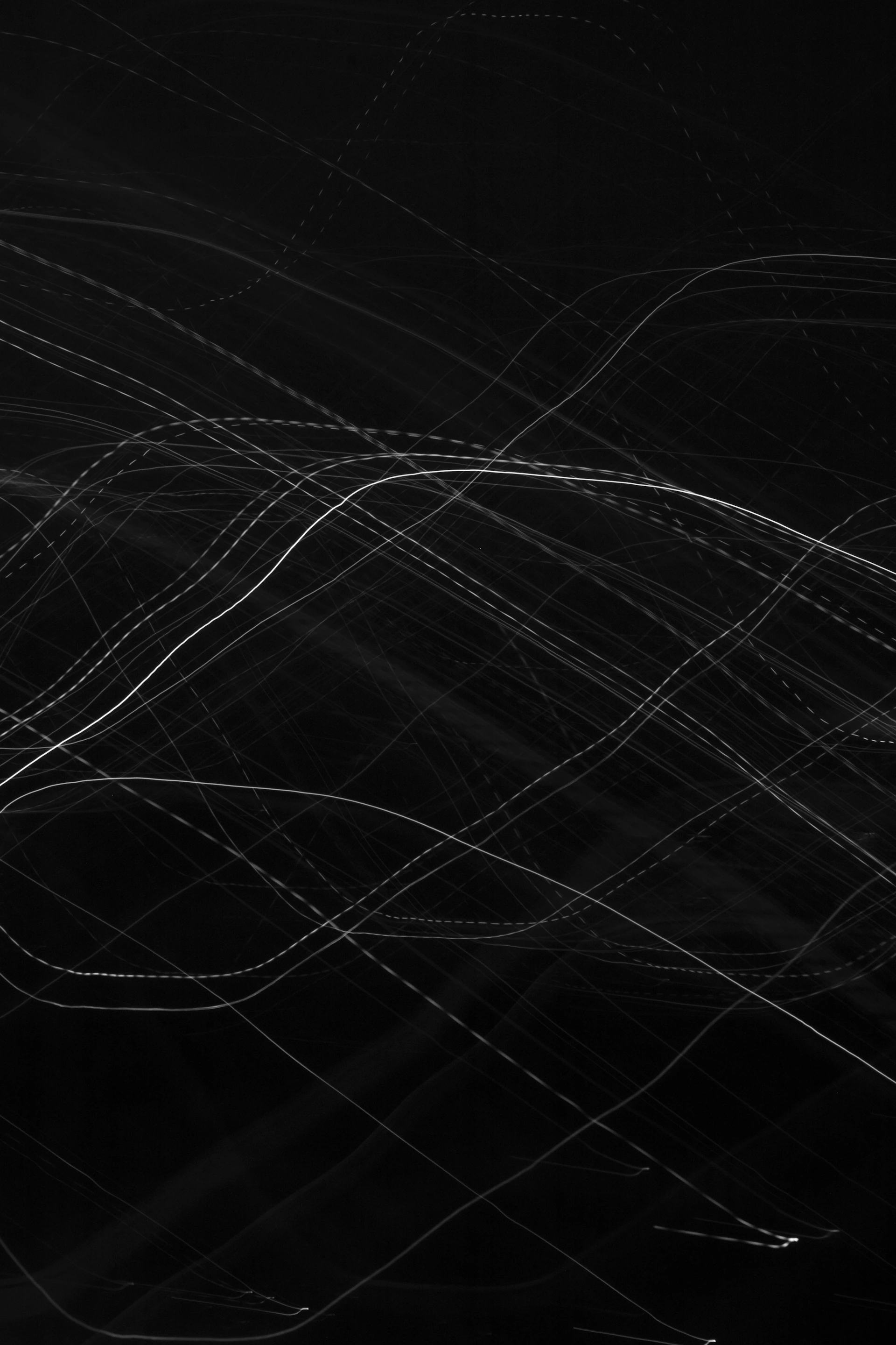 Abstract trails of light against a dark background.