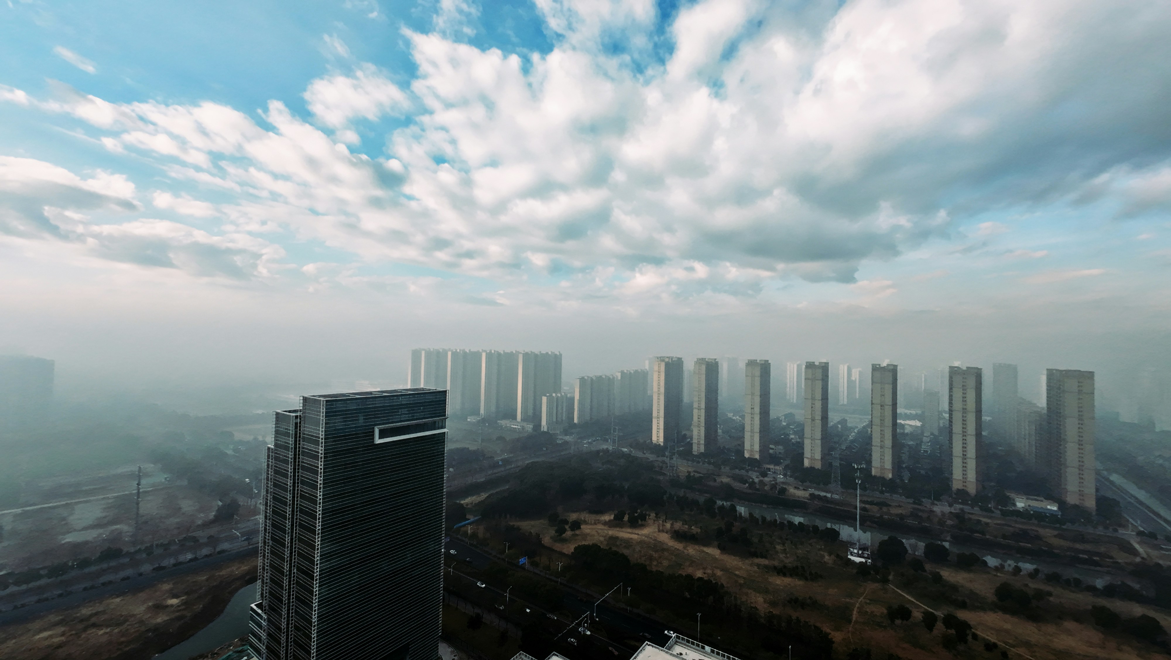 Cityscape view under a cloudy sky.