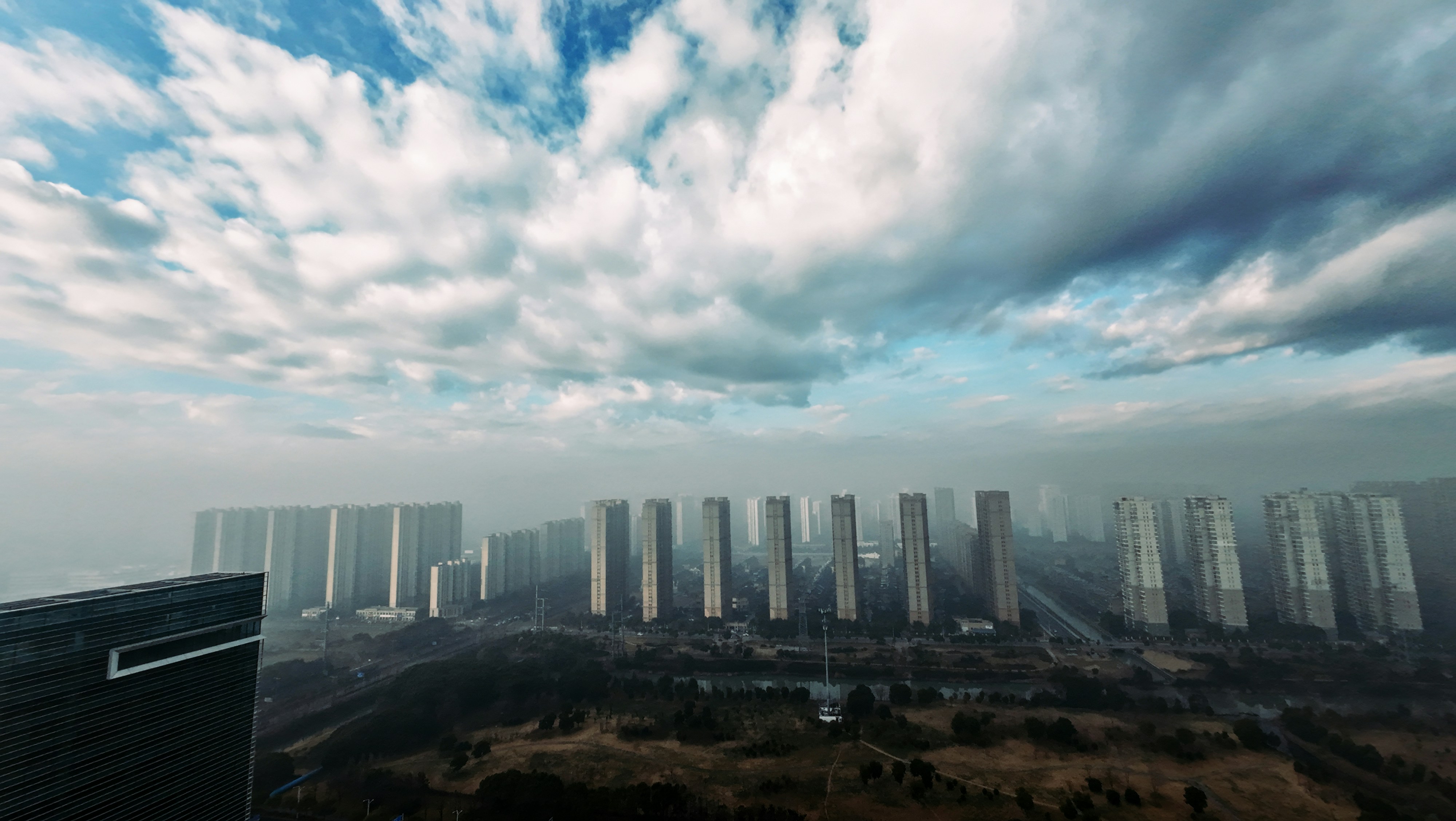 Skyscrapers line the skyline under a cloudy sky.