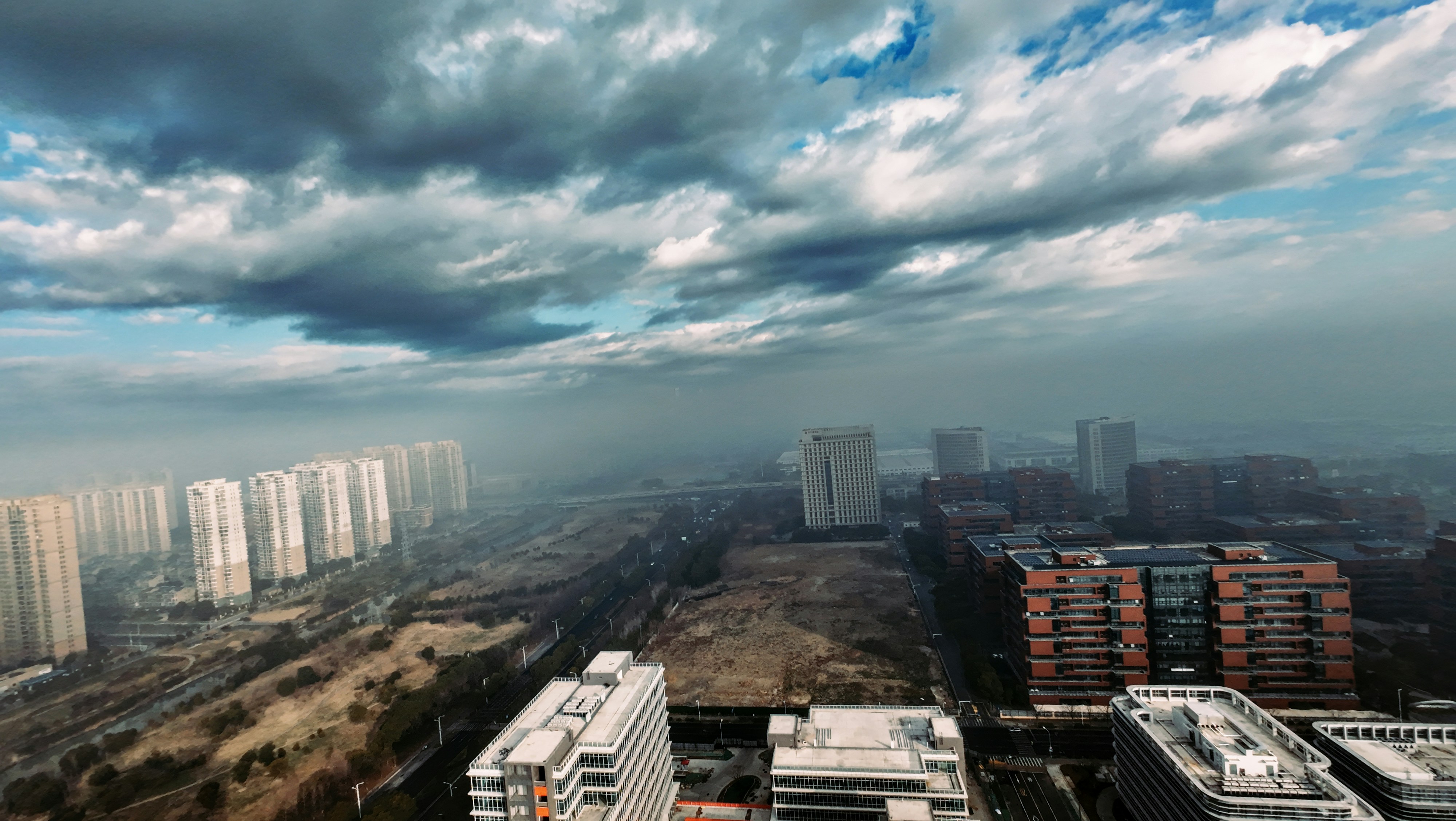 City under a cloudy and smoggy sky.
