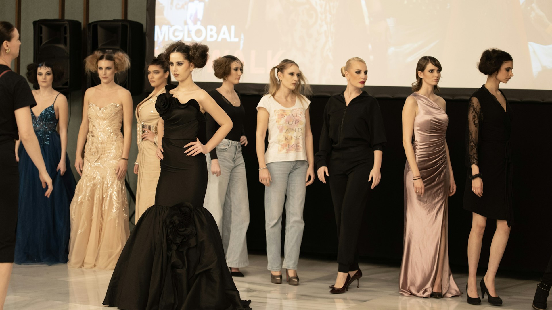Fashion models showcase outfits on a runway.