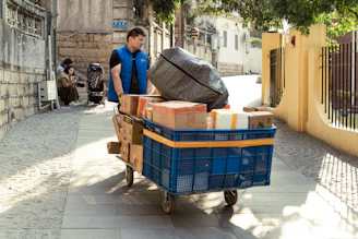 Delivery man transports packages on a cart.