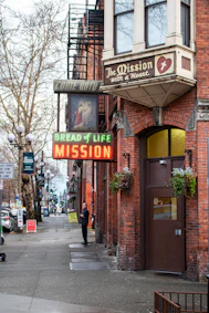 The bread of life mission building on a city street.