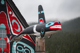 Orca carving adorns a building's side