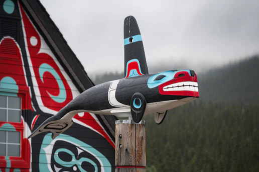 Orca carving adorns a building's side